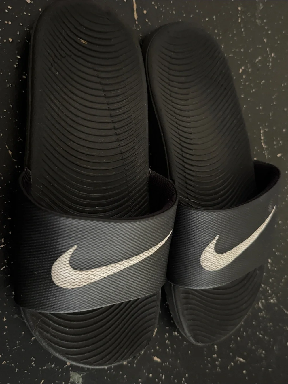 Nike Black Slides with White Swoosh Logos